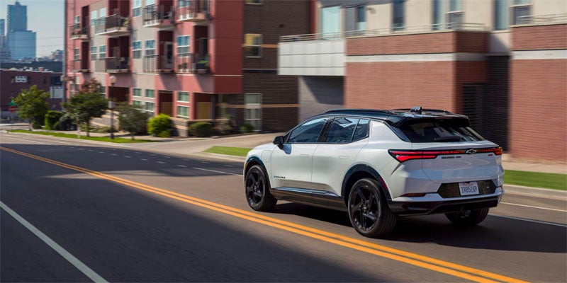 White 2025 Chevrolet Equinox EV driving in city
