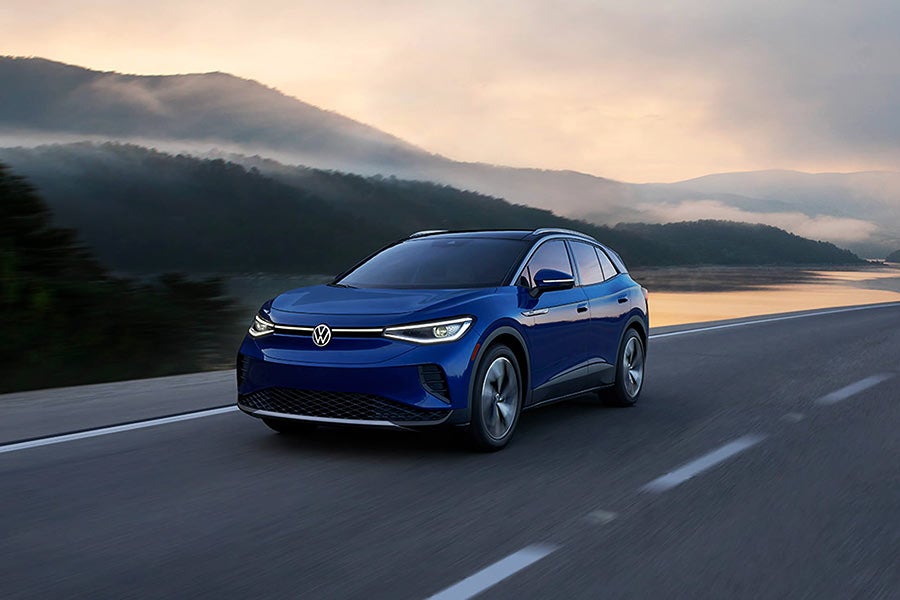 Dark blue Volkswagen ID4 driving at sunset